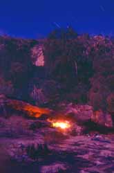 Firelit campsite, August